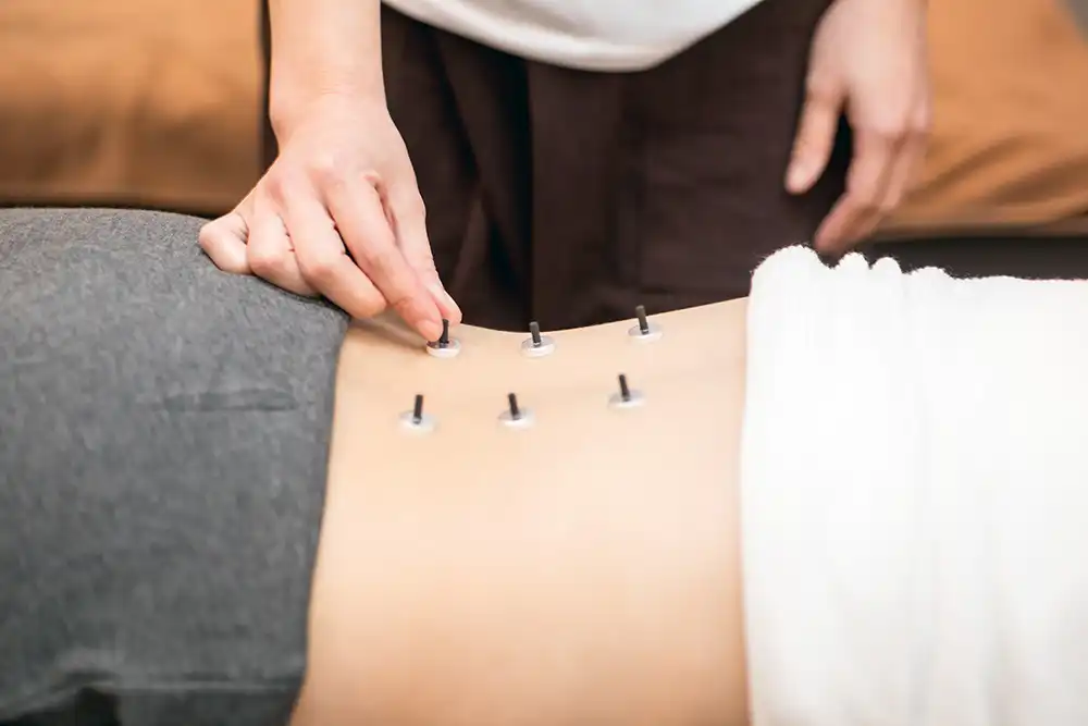 Practitioner using Electro Meridian Imaging device on wrist